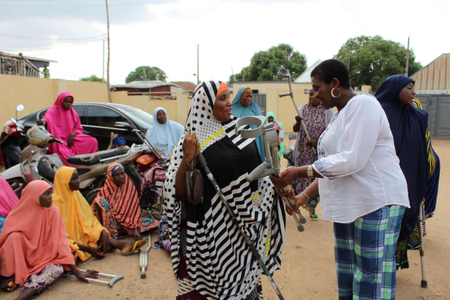 A PWD being handed one of the crutches